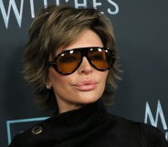 Lisa Rinna wearing sunglasses against a black background