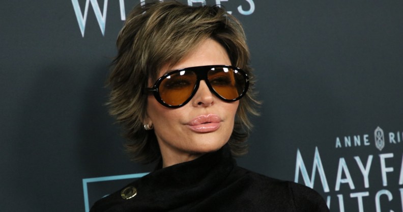 Lisa Rinna wearing sunglasses against a black background