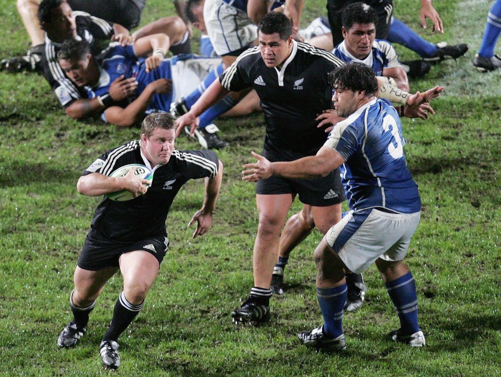 Campbell Johnstone of the Junior All Blacks runs around Jeremy Tomuli of Samoa during the Pacific 5 Nations game between the Junior All Blacks and Samoa at North Harbour Stadium June 09, 2006 in Auckland, New Zealand