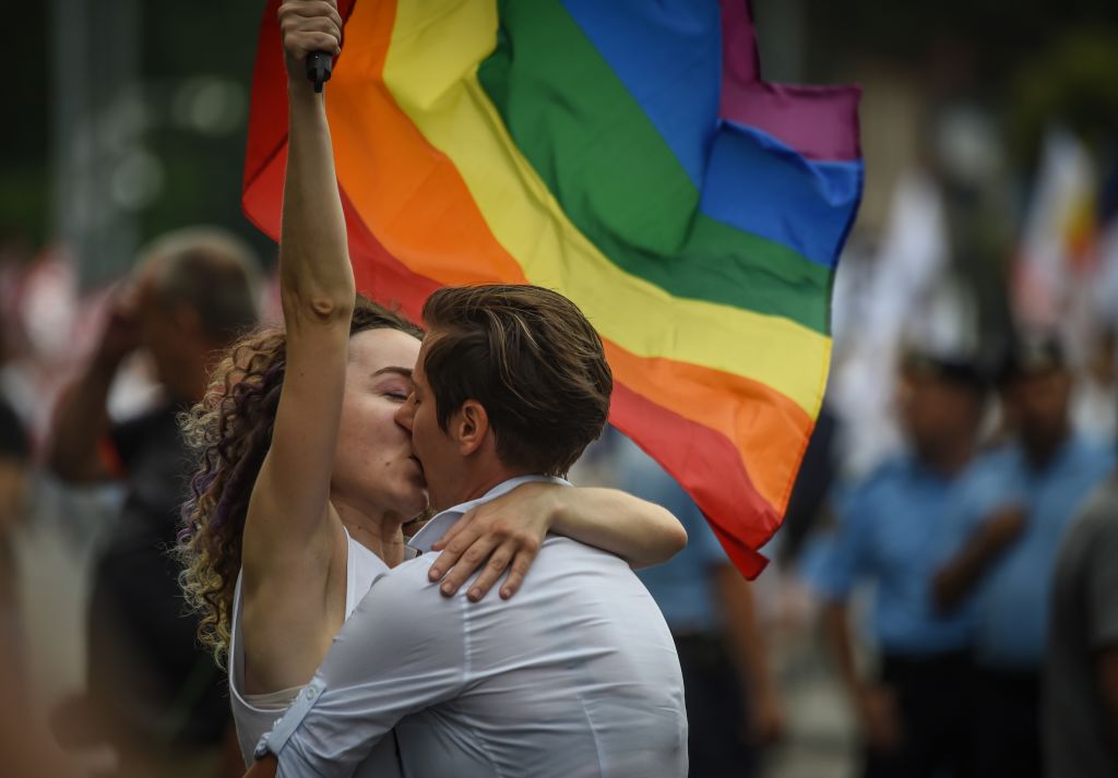 Two women kiss as they take part in the Bucharest Pride 2018 March.