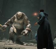 A student at Hogwarts uses a wand against a giant troll.