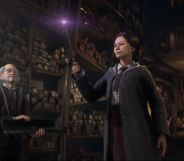 A student raises a wand in a Hogwarts wand shop.