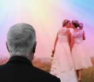 Two women kiss in wedding gowns while a man looks on