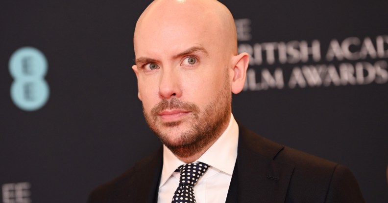 A photo of comedian Tom Allen wearing a black suit, white shirt and black and white patterned tie as he atends the British Academy Film Awards. (Getty)