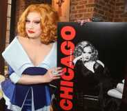 A promo photo of drag queen Jinkx Monsoon wearing a dark and light blue dress holding a poster for the Broadway production of Chicago
