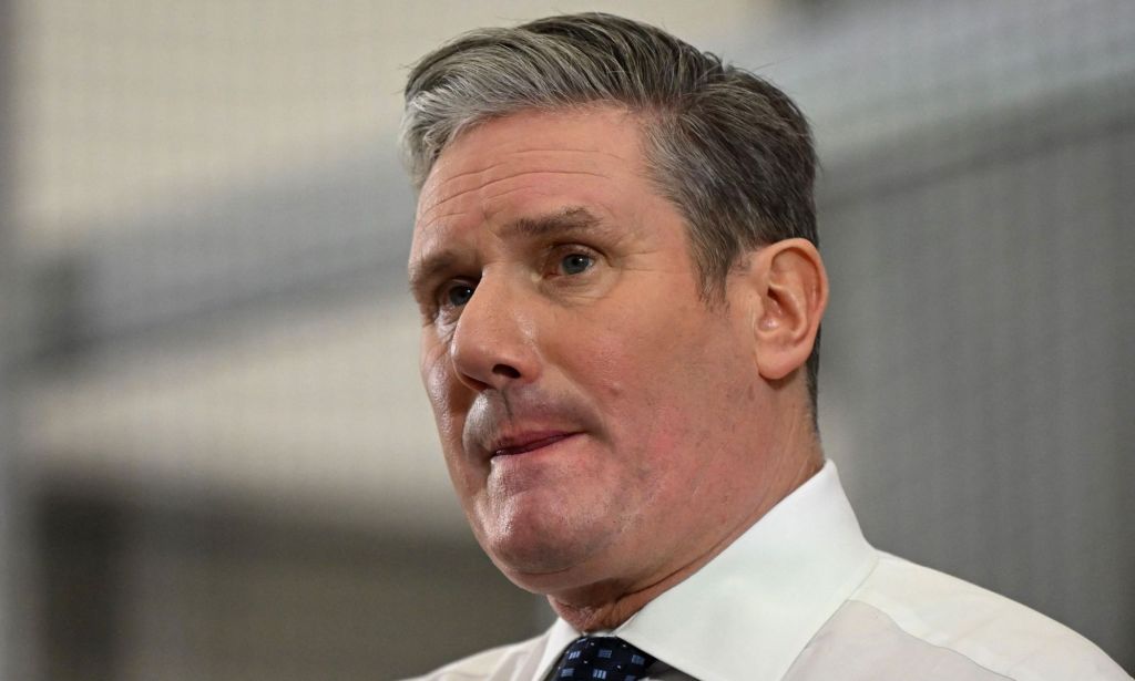 Keir Starmer in a suit and tie, looking off into the distance.