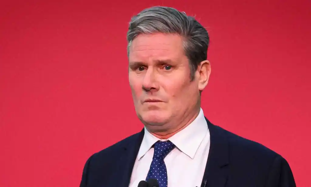 Labour leader Keir Starmer in front of a red background