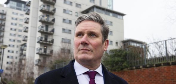 Keir Starmer pictured out canvassing wearing a suit and tie.