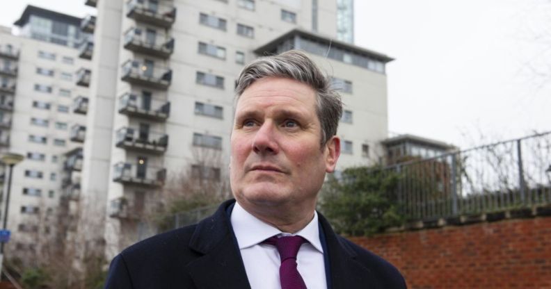 Keir Starmer pictured out canvassing wearing a suit and tie.