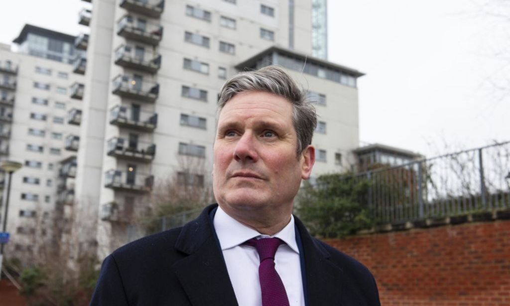 Keir Starmer pictured out canvassing wearing a suit and tie.