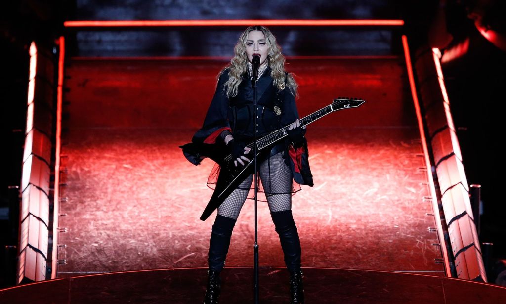 Madonna with a guitar on stage at the Rebel Heart tour.