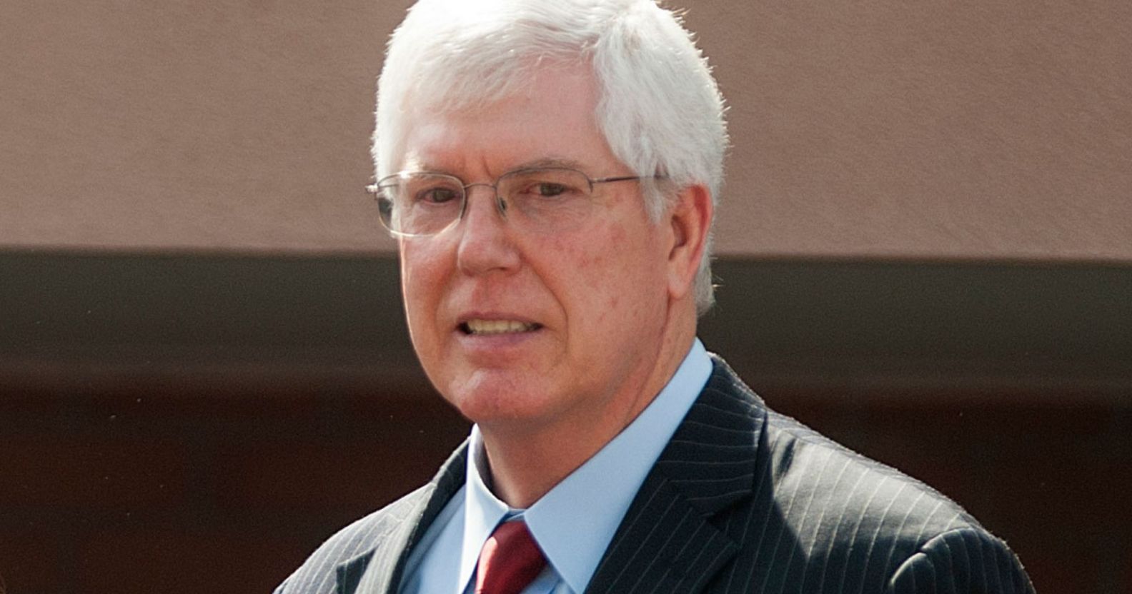 Mat Staver awkwardly smiles during a press conference.