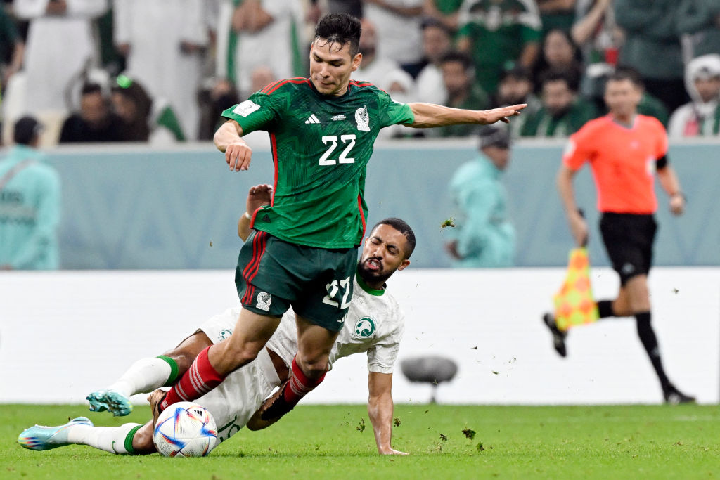 Saudi Arabia's midfielder #19 Hatan Babhir (R) tackles Mexico's forward #22 Hirving Lozano (L)  during the Qatar 2022 World Cup Group C football match between Saudi Arabia and Mexico.