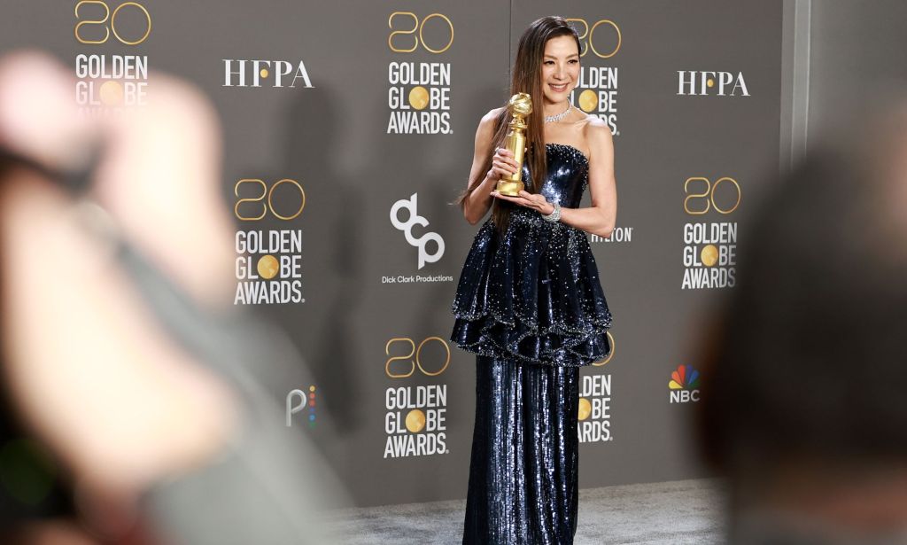 Michelle Yeoh in a sparkly dark blue peplum gown on the Golden Globes red carpet.