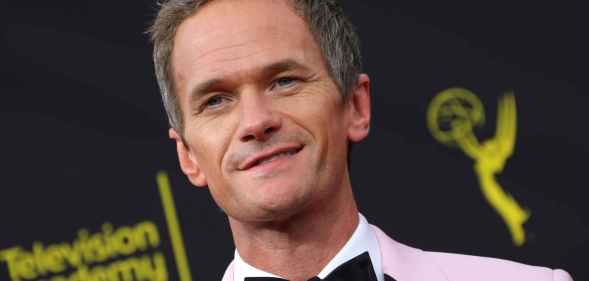 Neil Patrick Harris in a baby pink tuxedo and black bow tie
