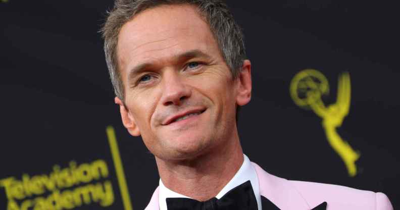 Neil Patrick Harris in a baby pink tuxedo and black bow tie
