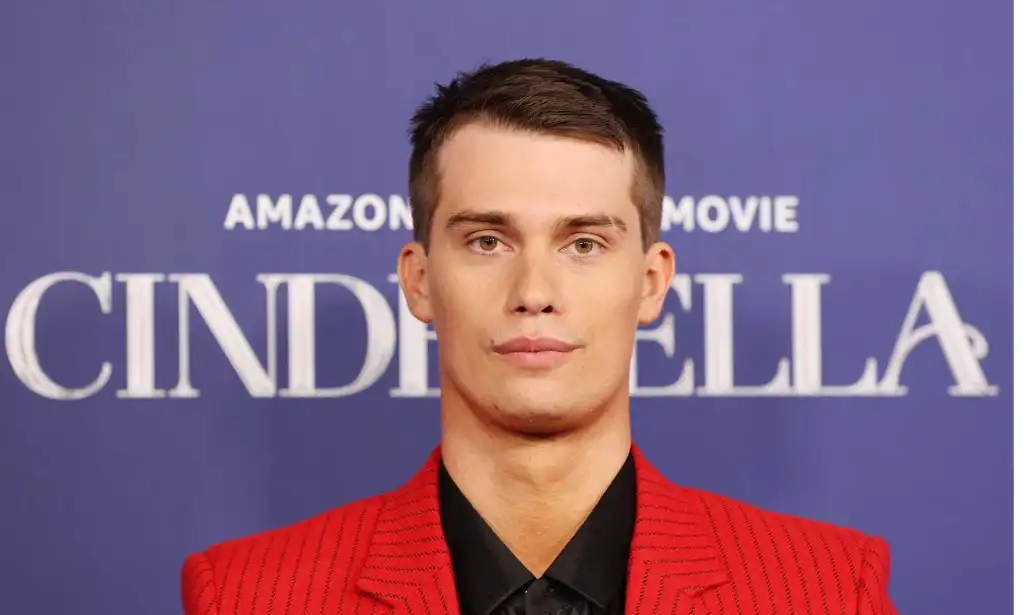 Nicholas Galitzine in a red jacket and black shirt on the red carpet for 2021 film Cinderella