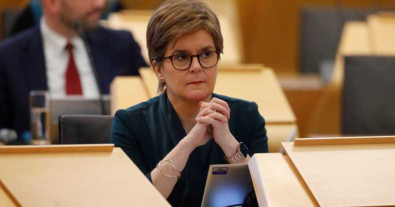 A photo of First minister Nicola Sturgeon sitting behind a desk in Holyrood, Edinburgh
