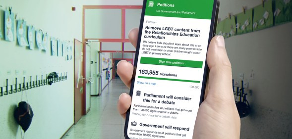 An image of a hand holding a phone showing a petition to pull LGBT content from schools