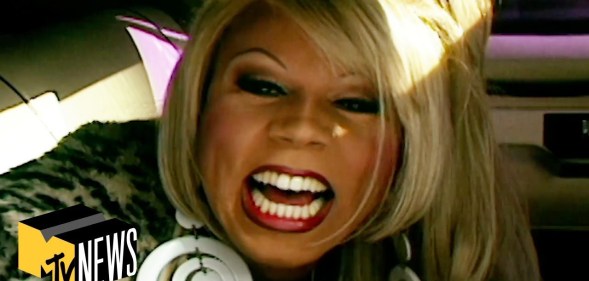 A still from MTV's News clip showing a close-up of drag queen RuPaul smiling to the camera witht the logo of MTV News appearing on the bottom left-hand side of the image