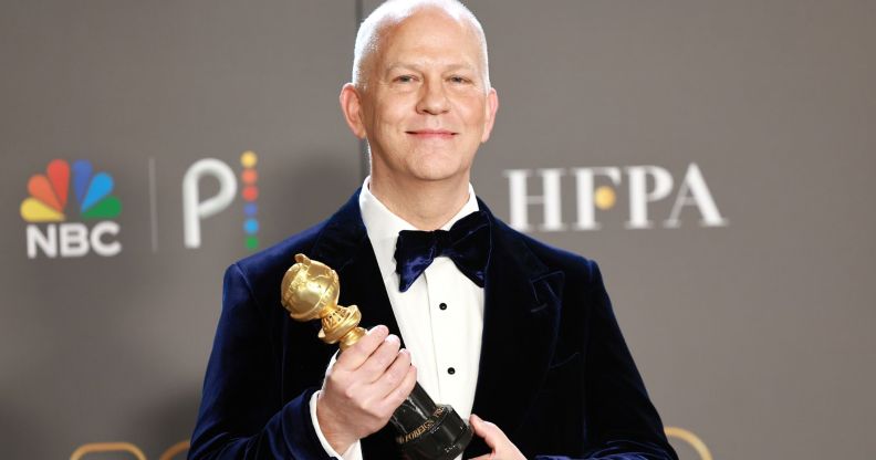 Ryan Murphy holding his Golden Globe Carol Burnett Award