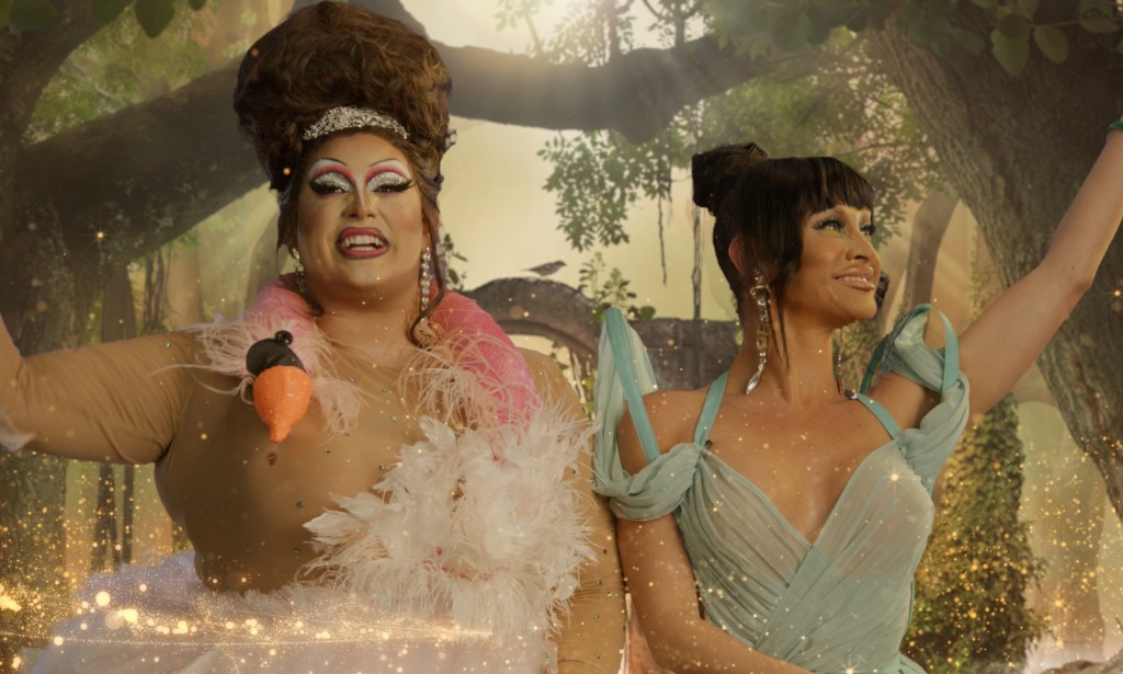 A screenshot from the GLAAD Award nominees presentation showing drag queens Salina Estitties wearing a white feather dress and Sasha Colby in a light blue dress against a jungle background