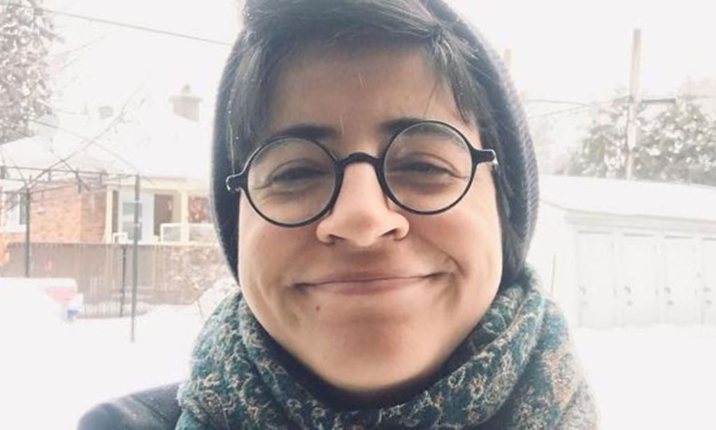 LGBTQ+ activist Sarah Hegazi wears grey winter clothing while standing outside