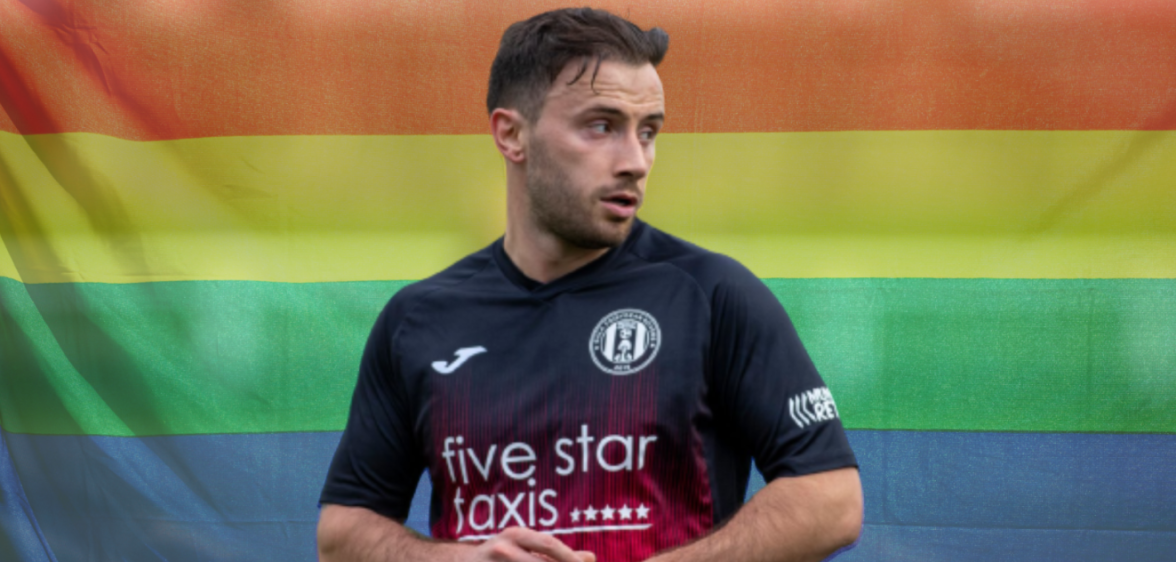 Zander Murray in front of an LGBTQ flag
