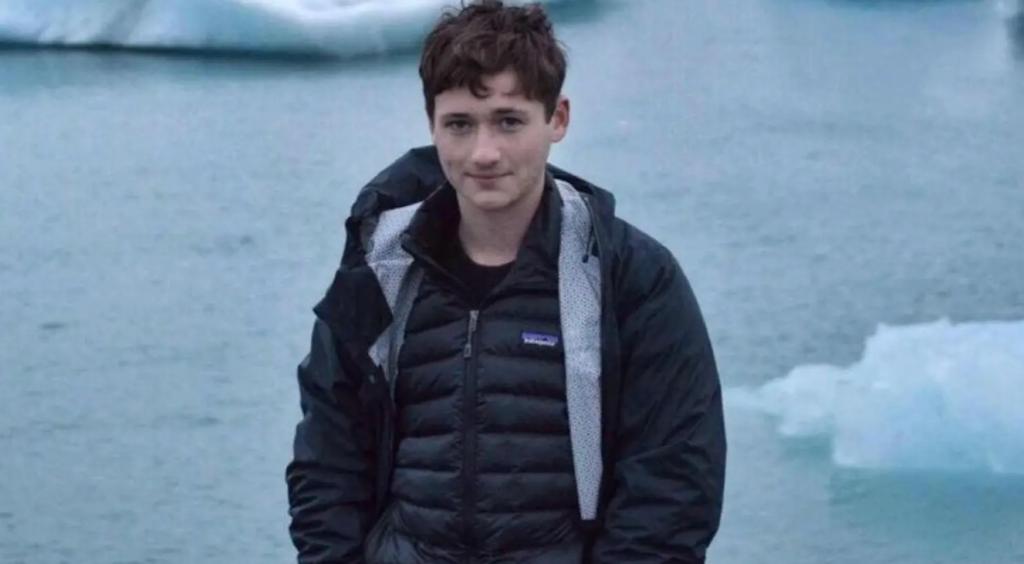 A photo of murdered gay Jewish student Blaze Bernstein pictured standing in front of frozen lake