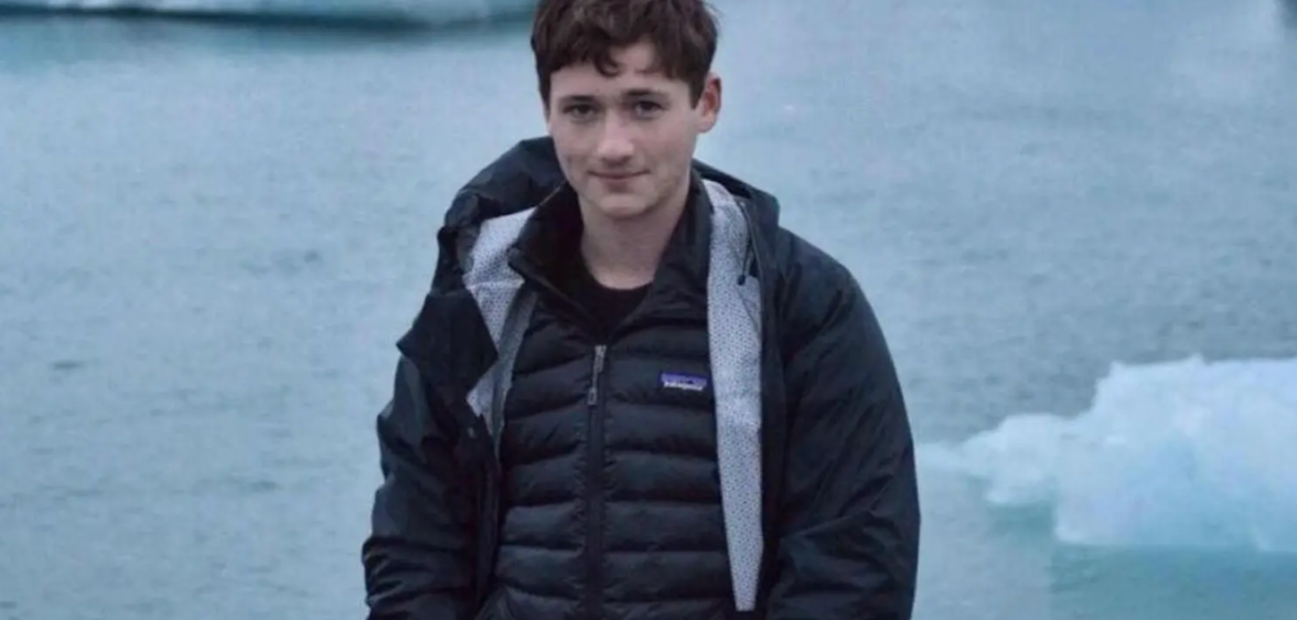 A photo of murdered gay Jewish student Blaze Bernstein pictured standing in front of frozen lake