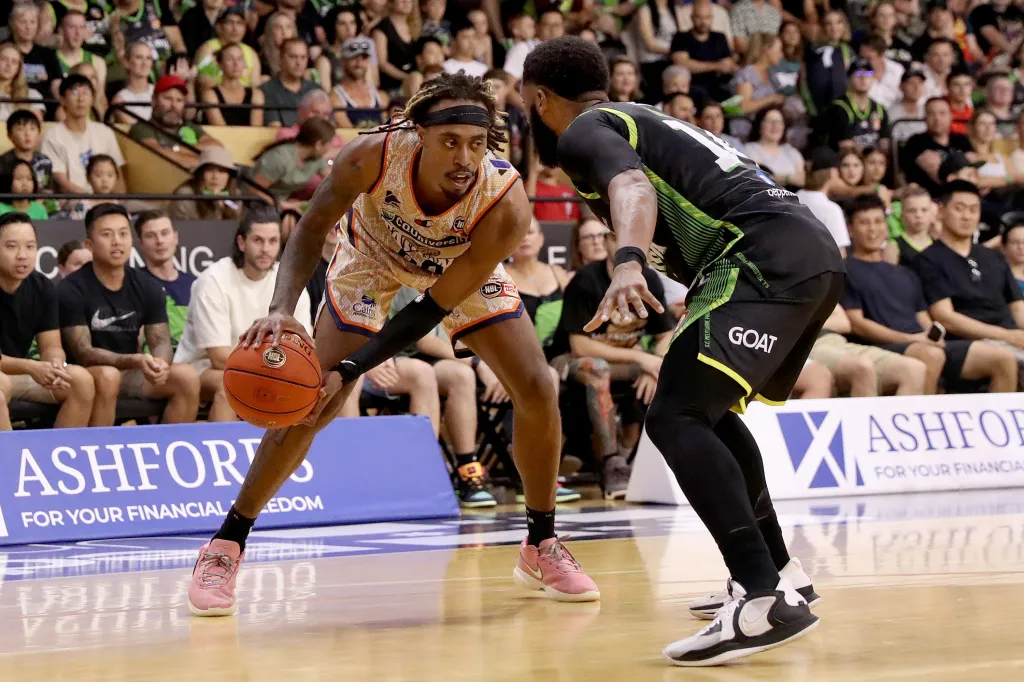 Tahjere McCall of the Taipans handles the ball against Gary Browne of the Phoenix during the round 17 NBL match between South East Melbourne Phoenix and Cairns Taipans at State Basketball Centre