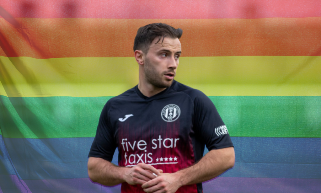 Footballer Zander Murray in front of a Pride rainbow