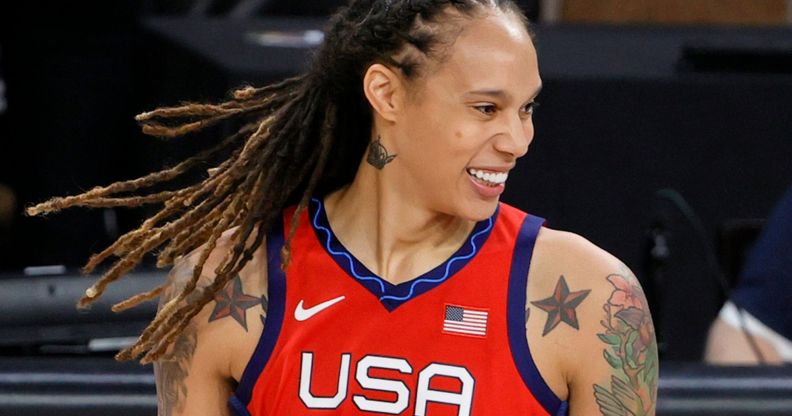 Brittney Griner smiles while wears a red, white and blue Team USA Olympic basketball jersey