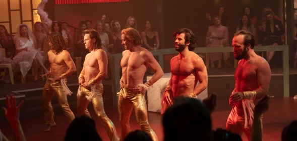 A still from US series Welcome to Chippendales shows five strippers performing in front of a crowd