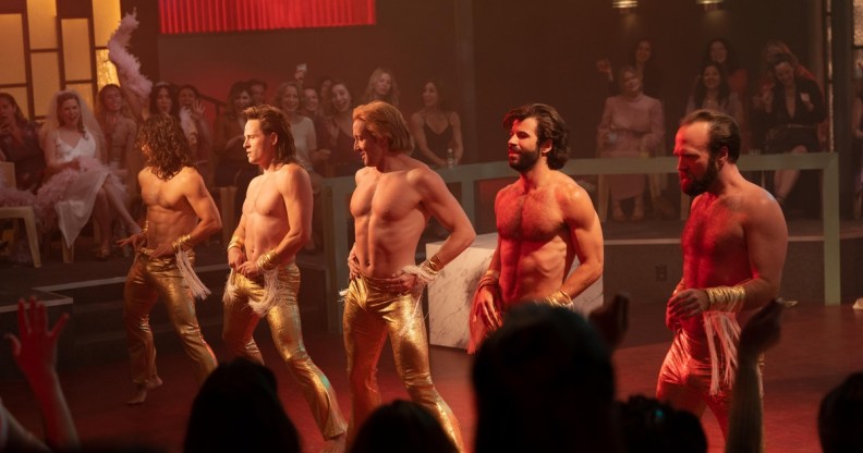 A still from US series Welcome to Chippendales shows five strippers performing in front of a crowd