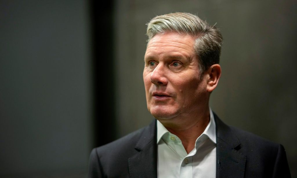 Labour Party leader Keir Starmer wears a white shirt and dark coloured jacket as he looks somewhere off camera