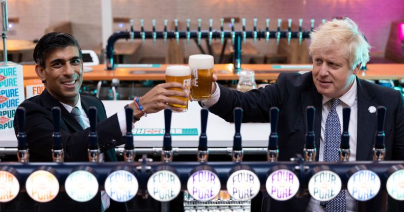 Boris Johnson and Rishi Sunak holding glasses on beer behind beer taps