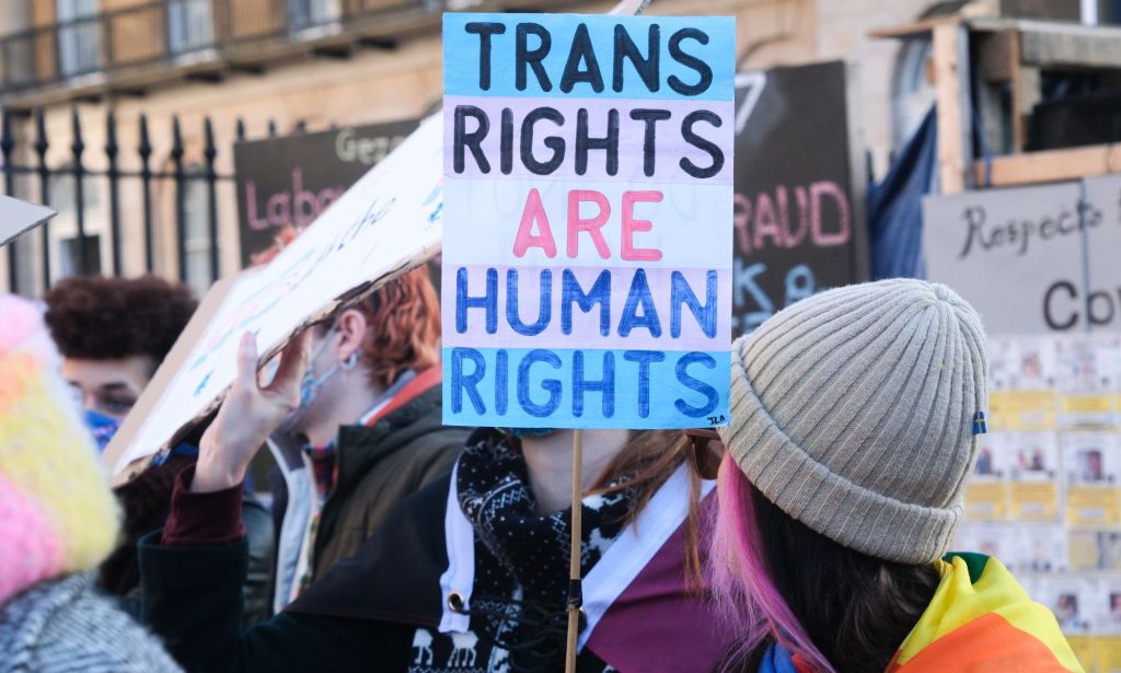 A trans rights supporter holds up a sign reading "Trans Rights are Human Rights" during a protest against the UK Goverment Section 35 stopping Scotland's gender recognition reform bill