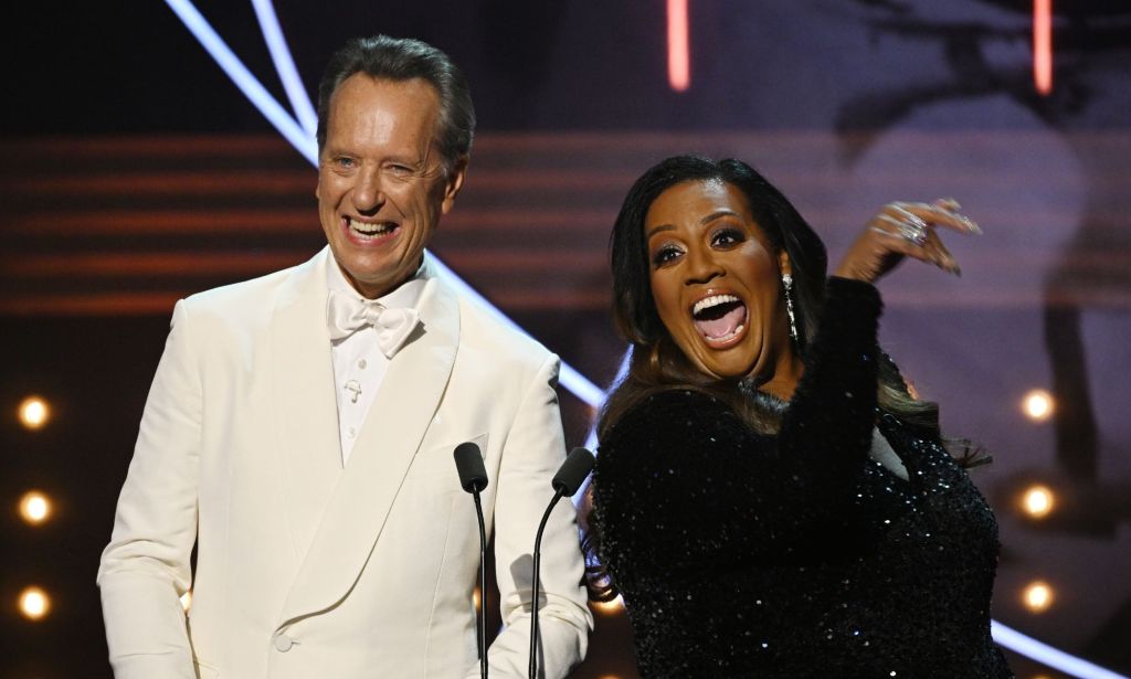 Richard E Grant and Alison Hammond on stage hosting the BAFTAs.