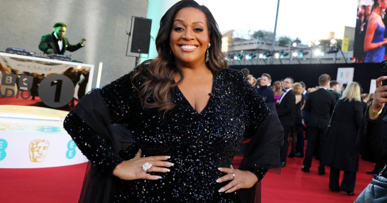 Alison Hammond with her hands on her waist as she smiles on the BAFTA red carpet