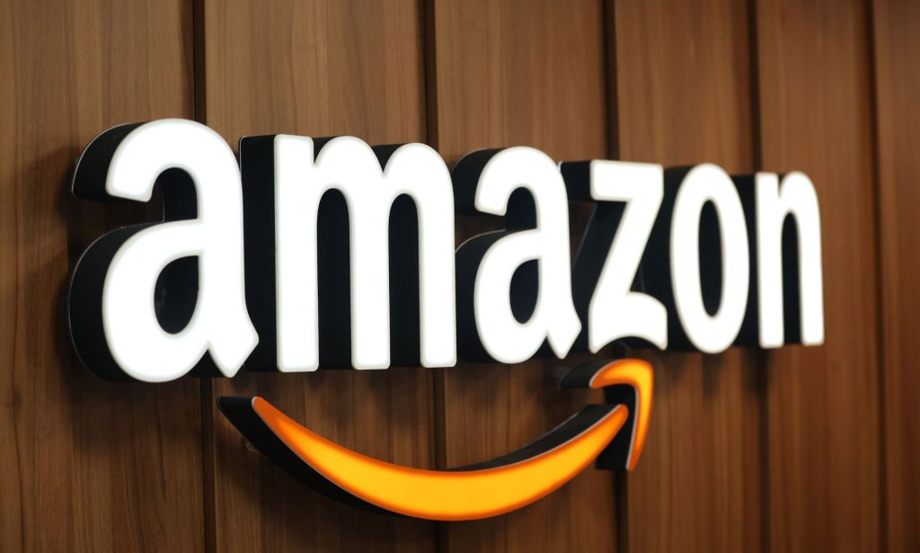 This is an image of the amazon logo on a brown wall. The letters A-M-A-Z-O-N are in white