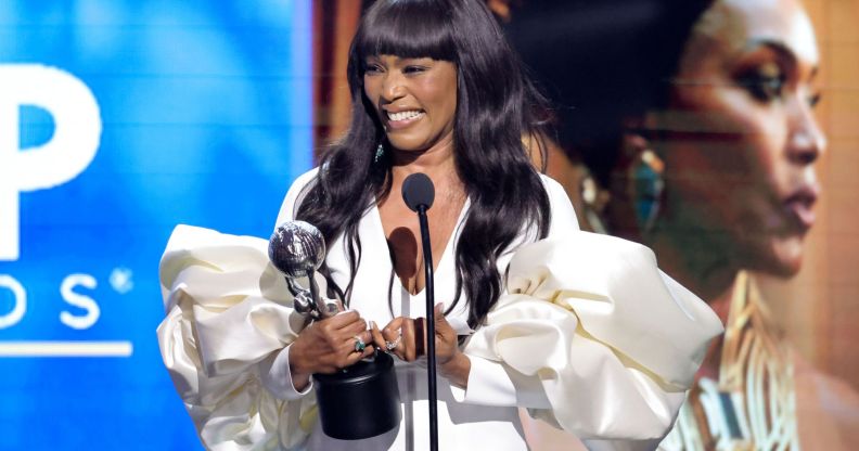 Angela Bassett accepting an award at the NAACP awards.