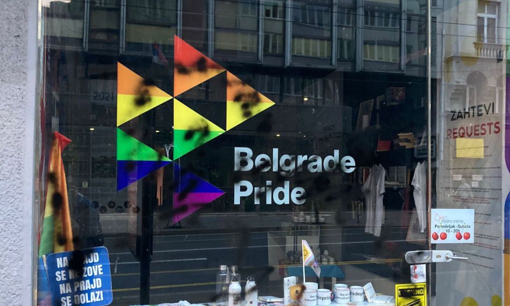 A vandalised Belgrade Pride sign, with graffiti across it.