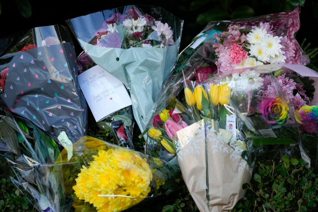 Floral tributes are left as police attend the scene where 16-year-old Brianna Ghey was found with multiple stab wounds on a path at Linear Park in Culcheth. (Christopher 