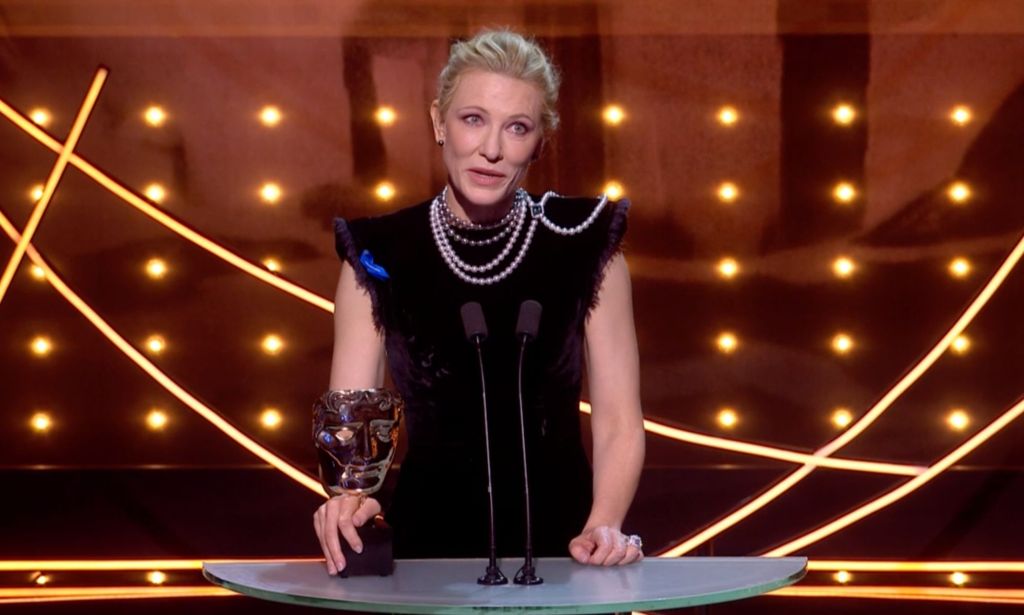 Cate Blanchett on stage at the 2023 BAFTA Awards holding her BAFTA for Best Actress.
