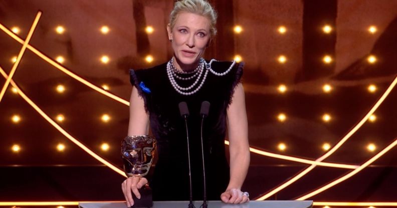 Cate Blanchett on stage at the 2023 BAFTA Awards holding her BAFTA for Best Actress.