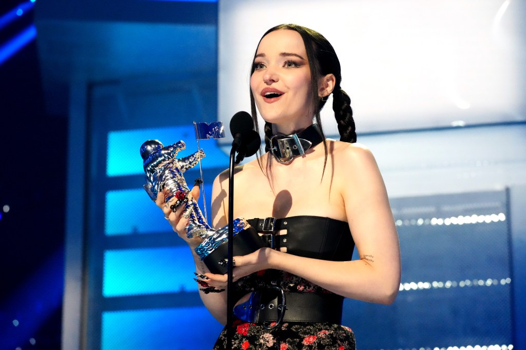 Dove Cameron accepts the award for Best New Artist. (Jeff Kravitz/Getty)