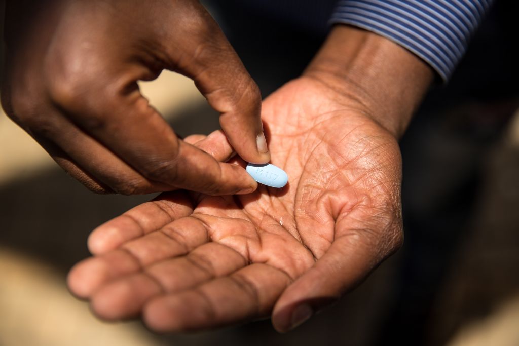 A person holds a PrEP pill, a medication that prevents a person from contracting HIV.