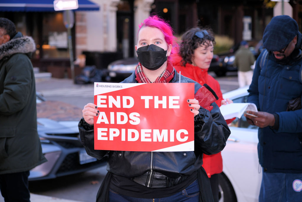 A person holds a sign that reads "End the AIDS epidemic" at a World AIDS Day event in New York City on 1 December 2022. 