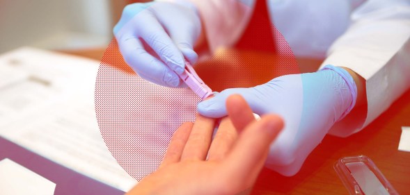 A medical professional's gloved hands as they take a blood sample from a person's finger to test for HIV.